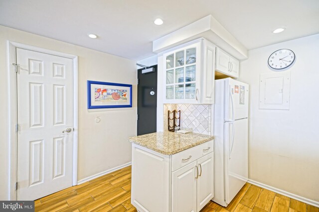 604 Dover House Rd Unit 604S, Bethany Beach, DE 19930 - kitchen with freestanding refrigerator, baseboards, white cabinetry, light wood-style flooring, and recessed lighting