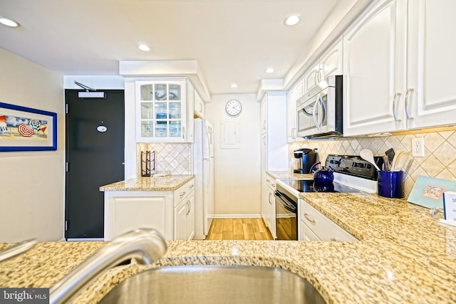 604 Dover House Rd Unit 604S, Bethany Beach, DE 19930 - kitchen featuring stainless steel microwave, range with electric stovetop, light wood-style floors, white cabinetry, and recessed lighting