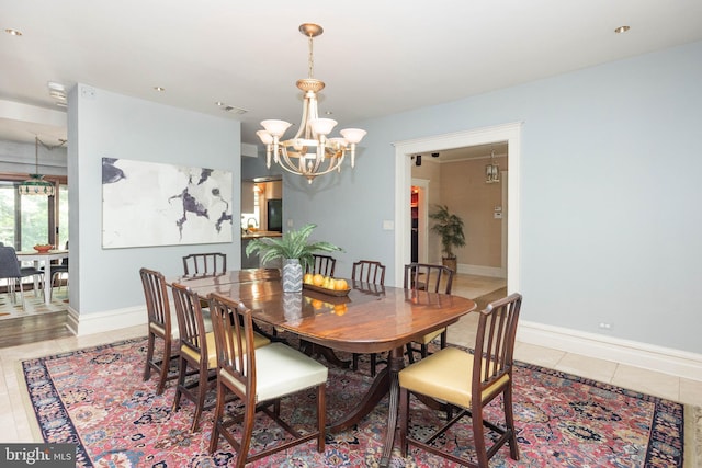 403 Club Rd, Baltimore, MD 21210 - dining room featuring a chandelier, light tile patterned floors, and baseboards