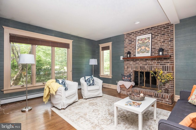 403 Club Rd, Baltimore, MD 21210 - living room with baseboard heating, wood finished floors, a brick fireplace, and baseboards
