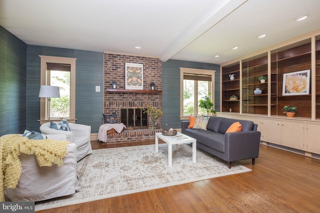 403 Club Rd, Baltimore, MD 21210 - living room with wood finished floors, beam ceiling, and a brick fireplace