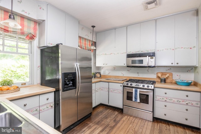 403 Club Rd, Baltimore, MD 21210 - kitchen with appliances with stainless steel finishes, light countertops, white cabinets, and wood-type flooring