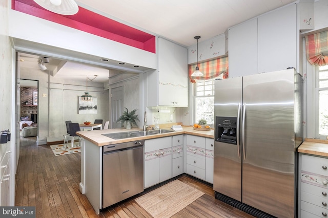 403 Club Rd, Baltimore, MD 21210 - kitchen featuring stainless steel appliances, dark wood-style floors, white cabinets, and a peninsula