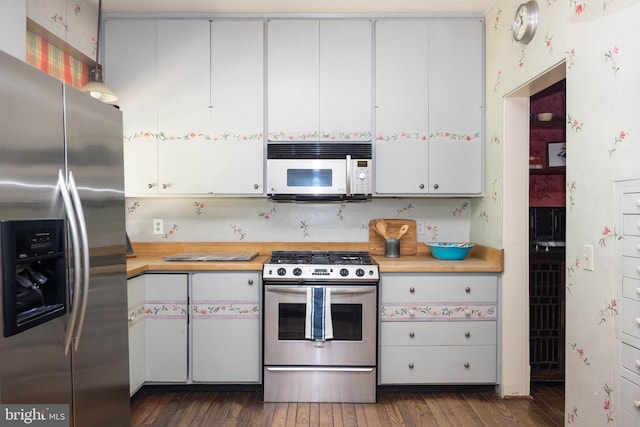 403 Club Rd, Baltimore, MD 21210 - kitchen featuring stainless steel appliances, light countertops, dark wood-style flooring, and white cabinets
