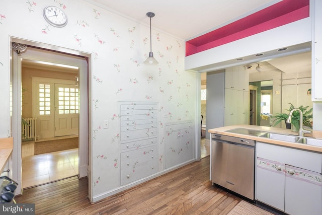403 Club Rd, Baltimore, MD 21210 - kitchen featuring stainless steel dishwasher, wood-type flooring, decorative light fixtures, white cabinets, and wallpapered walls