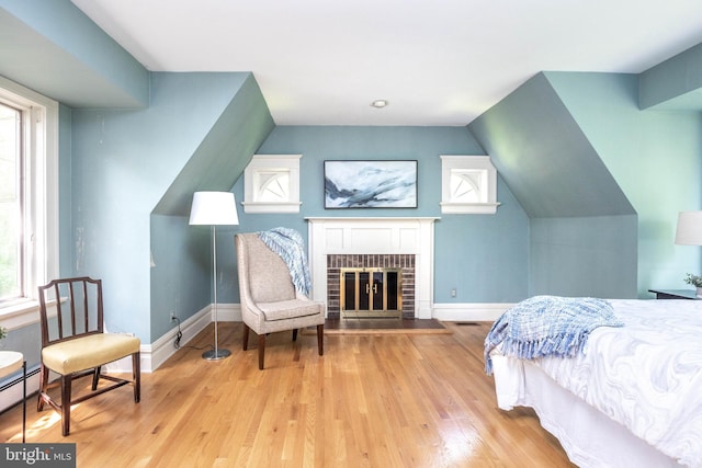 403 Club Rd, Baltimore, MD 21210 - bedroom with wood finished floors, a fireplace, vaulted ceiling, a baseboard radiator, and baseboards