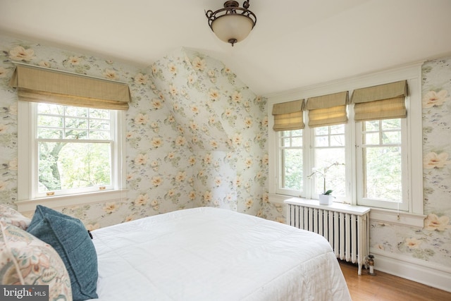 403 Club Rd, Baltimore, MD 21210 - bedroom with radiator heating unit, wood finished floors, wallpapered walls, lofted ceiling, and baseboards