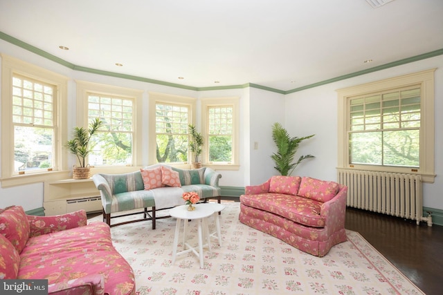 403 Club Rd, Baltimore, MD 21210 - living room with radiator heating unit, healthy amount of natural light, wood finished floors, crown molding, and baseboards