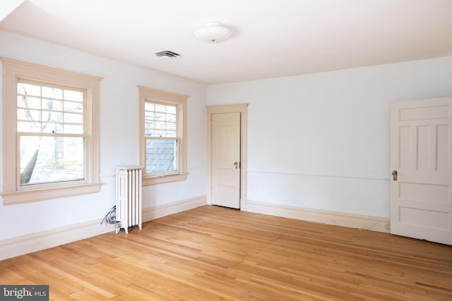 403 Club Rd, Baltimore, MD 21210 - unfurnished room with radiator, light wood finished floors, and baseboards