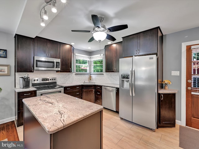 407 Vaughn Rd, Royersford, PA 19468 - kitchen featuring stainless steel appliances, ceiling fan, tasteful backsplash, dark brown cabinets, and light stone counters