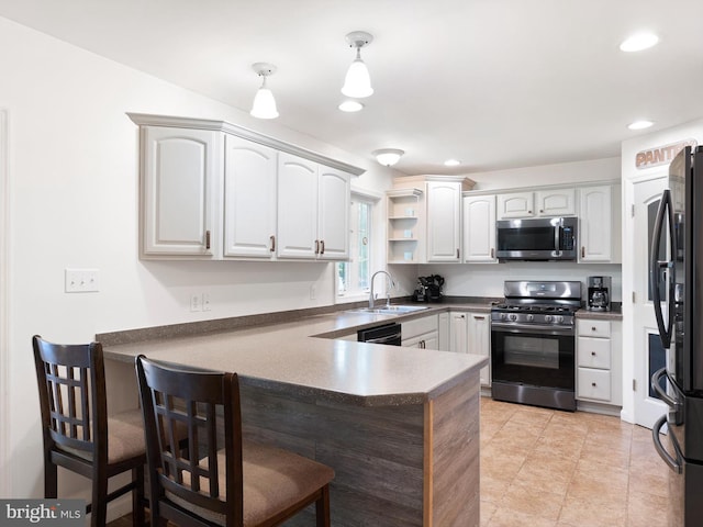 5185 Turkey Point Road, North East, MD 21901 - kitchen with stainless steel microwave, gas range, a peninsula, freestanding refrigerator, and dark countertops