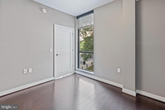 1320 Fenwick Ln Unit 201, Silver Spring, MD 20910 - unfurnished room with floor to ceiling windows, baseboards, dark wood-type flooring, and a smoke detector