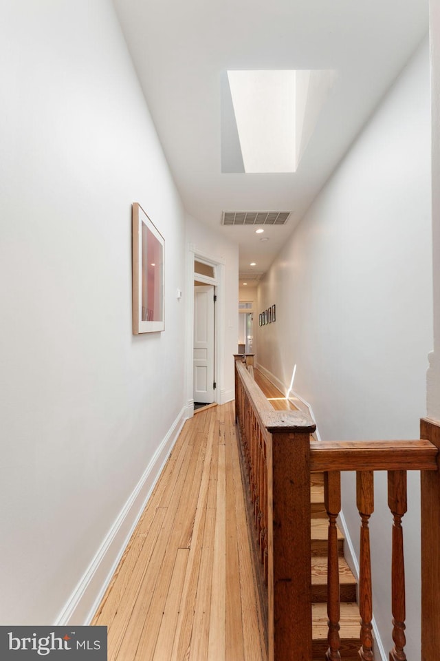111 8th St SE, Washington, DC 20003 - corridor featuring a skylight, light wood-style flooring, and baseboards