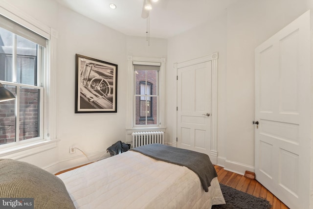 111 8th St SE, Washington, DC 20003 - bedroom with radiator, wood finished floors, and baseboards