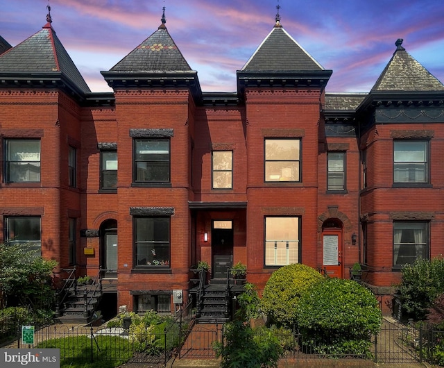 111 8th St SE, Washington, DC 20003 - view of front facade featuring brick siding, a fenced front yard, and a gate