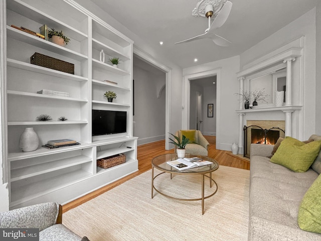 111 8th St SE, Washington, DC 20003 - living room with a brick fireplace, wood finished floors, a ceiling fan, recessed lighting, and baseboards