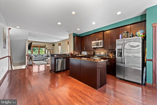 4500 Fait Ave, Baltimore, MD 21224 - kitchen with stainless steel appliances, dark wood-style floors, open floor plan, dark brown cabinetry, and dark stone countertops