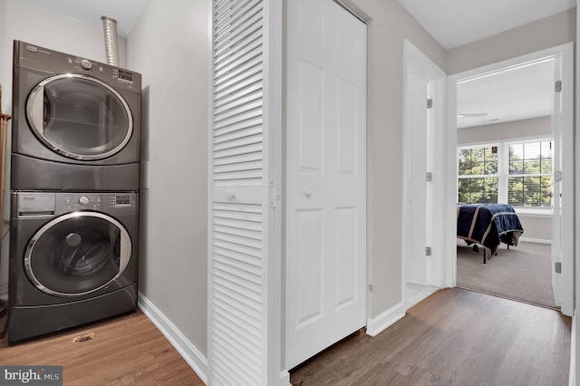 1601 Carriage House Ter Unit D, Silver Spring, MD 20904 - washroom featuring estacked washer and dryer, wood finished floors, and baseboards