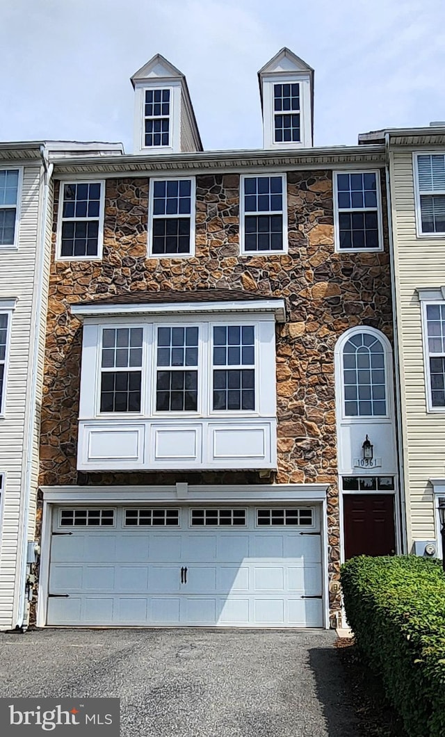 10361 Bridle Ct, Hagerstown, MD 21740 - townhome / multi-family property with stone siding, an attached garage, and asphalt driveway