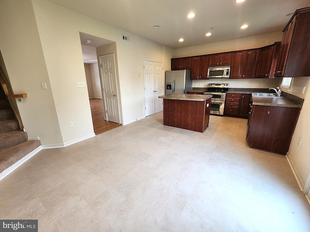10361 Bridle Ct, Hagerstown, MD 21740 - kitchen with appliances with stainless steel finishes, a kitchen island, baseboards, a sink, and dark brown cabinetry