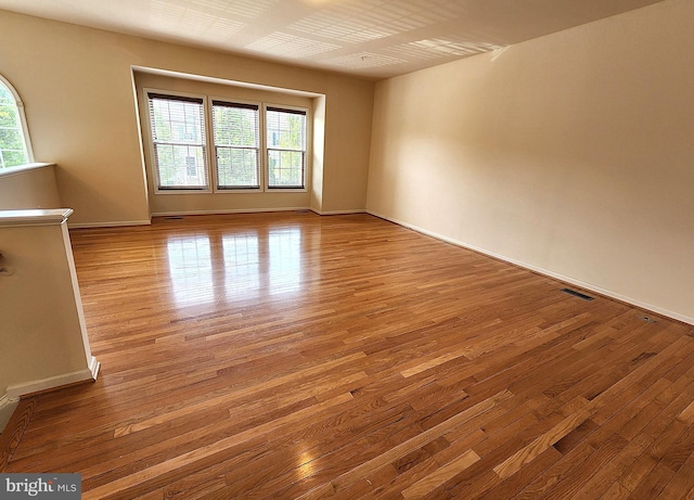 10361 Bridle Ct, Hagerstown, MD 21740 - empty room with healthy amount of natural light, hardwood / wood-style floors, and baseboards