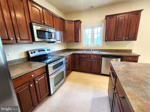 10361 Bridle Ct, Hagerstown, MD 21740 - kitchen with appliances with stainless steel finishes, a sink, dark countertops, and light floors