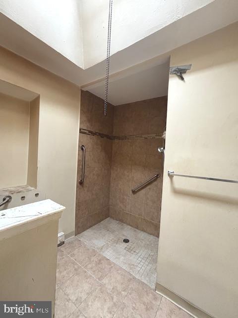 5328 Willows Ave, Philadelphia, PA 19143 - full bathroom featuring vanity, tiled shower, and tile patterned flooring