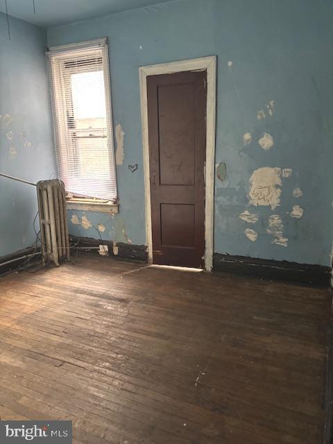 5328 Willows Ave, Philadelphia, PA 19143 - empty room featuring dark wood-style flooring and radiator heating unit