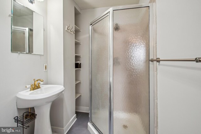 3305 Fleet St, Baltimore, MD 21224 - full bath featuring a stall shower, tile patterned flooring, and baseboards