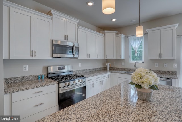 35141 Wright Way, Millsboro, DE 19966 - kitchen featuring appliances with stainless steel finishes, a sink, white cabinets, recessed lighting, and pendant lighting