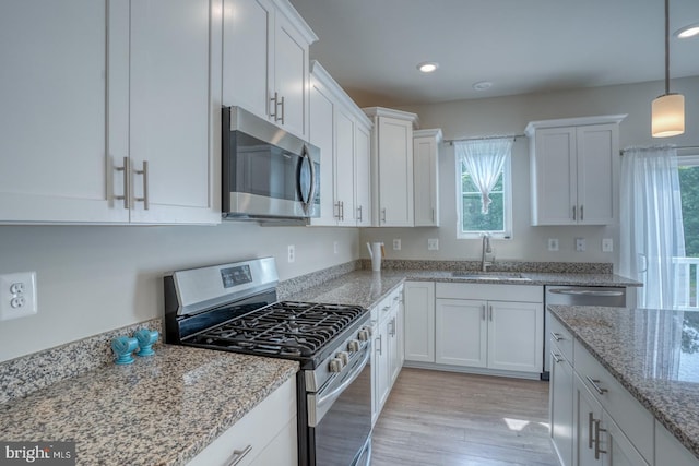 35141 Wright Way, Millsboro, DE 19966 - kitchen with appliances with stainless steel finishes, a sink, plenty of natural light, white cabinetry, and recessed lighting