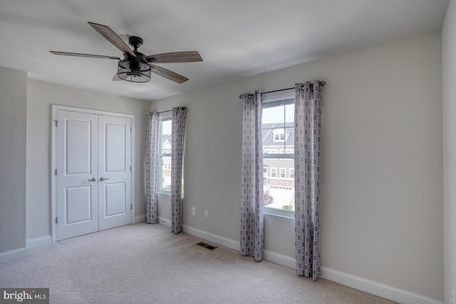 35141 Wright Way, Millsboro, DE 19966 - unfurnished bedroom with multiple windows, carpet flooring, a closet, and a ceiling fan
