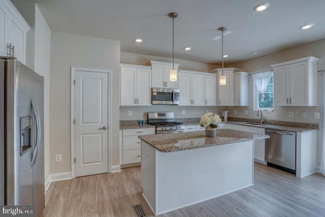 35141 Wright Way, Millsboro, DE 19966 - kitchen with appliances with stainless steel finishes, light wood finished floors, a sink, white cabinets, and recessed lighting