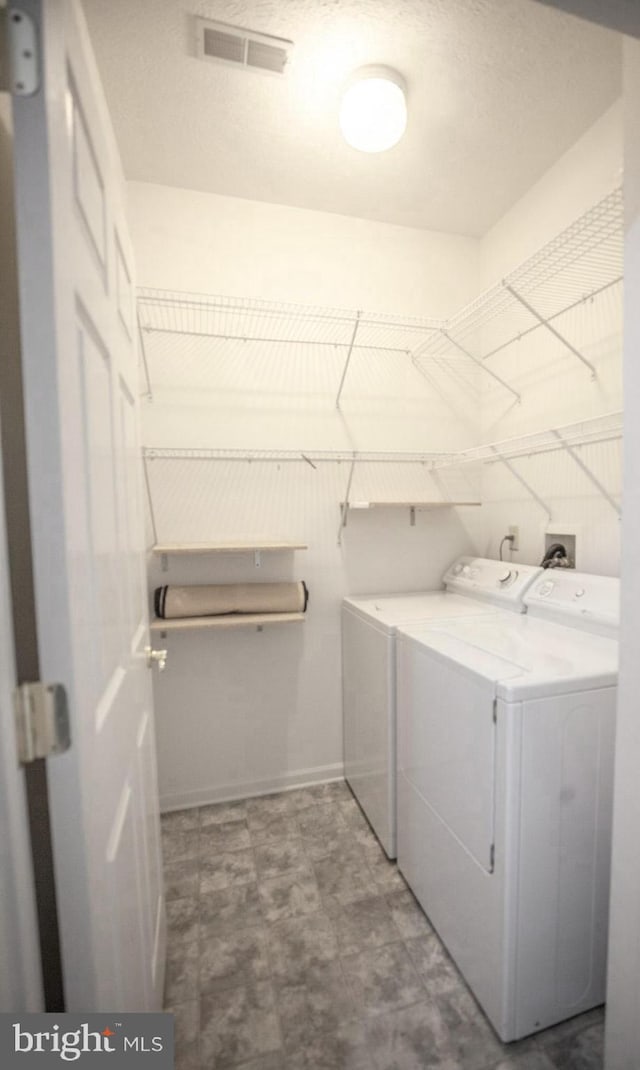 301 Sunbrook Ln Unit 89, Hagerstown, MD 21742 - laundry area featuring washer and clothes dryer, tile patterned floors, and baseboards