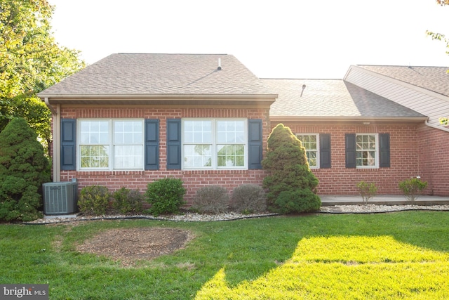 301 Sunbrook Ln Unit 89, Hagerstown, MD 21742 - view of property exterior featuring central AC, a yard, brick siding, and roof with shingles
