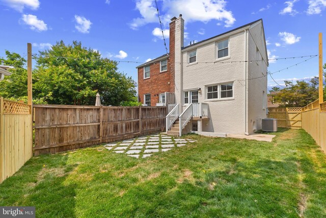 2402 E Randolph Ave, Alexandria, VA 22301 - rear view of property featuring central air condition unit, brick siding, and a chimney