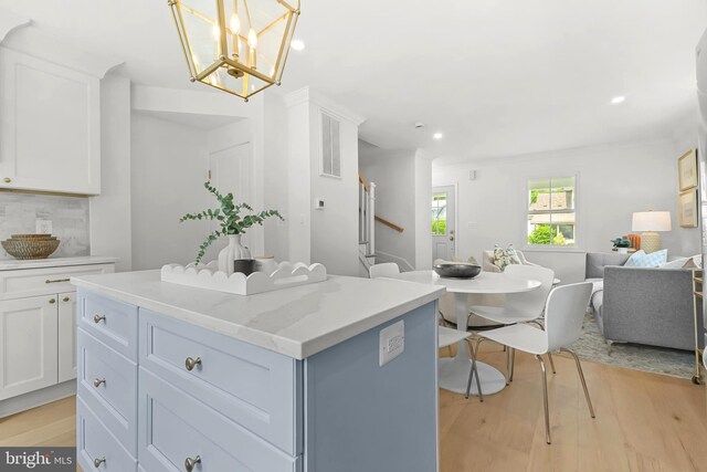 2402 E Randolph Ave, Alexandria, VA 22301 - kitchen featuring a kitchen island, white cabinets, light wood finished floors, open floor plan, and recessed lighting
