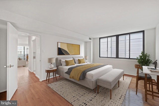 1140 23rd St NW Unit 903, Washington, DC 20037 - bedroom featuring light wood-style flooring and baseboards