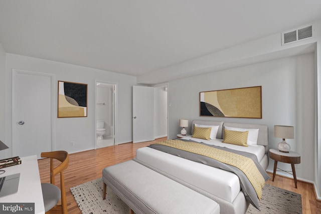 1140 23rd St NW Unit 903, Washington, DC 20037 - bedroom featuring wood finished floors, ensuite bath, and baseboards
