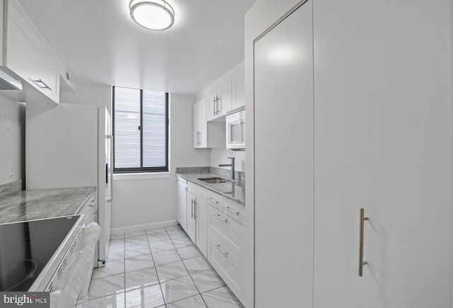 1140 23rd St NW Unit 903, Washington, DC 20037 - kitchen featuring light marble finish flooring, white appliances, baseboards, a sink, and white cabinets