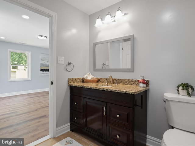 8211 Hocking Pl, Alexandria, VA 22309 - bathroom with vanity, toilet, baseboards, wood finished floors, and recessed lighting