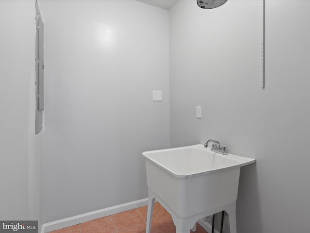 8211 Hocking Pl, Alexandria, VA 22309 - washroom with light tile patterned flooring, a sink, and baseboards