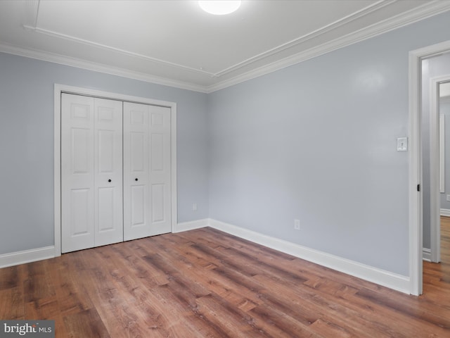 8211 Hocking Pl, Alexandria, VA 22309 - unfurnished bedroom featuring wood finished floors, a closet, baseboards, and crown molding