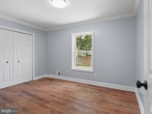 8211 Hocking Pl, Alexandria, VA 22309 - unfurnished bedroom with dark wood finished floors, ornamental molding, a closet, and baseboards