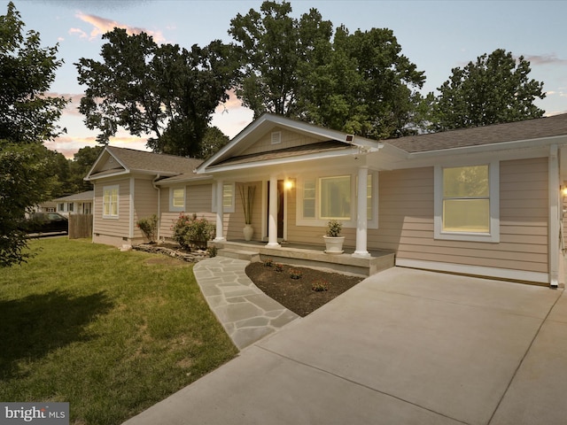 8211 Hocking Pl, Alexandria, VA 22309 - ranch-style home featuring covered porch, a front yard, and a shingled roof