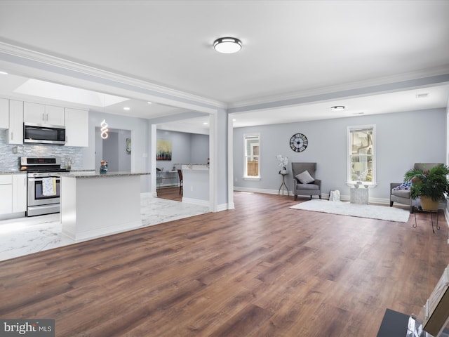 8211 Hocking Pl, Alexandria, VA 22309 - kitchen featuring stainless steel appliances, open floor plan, white cabinets, crown molding, and backsplash