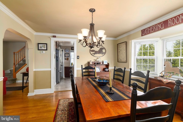 1864 Edge Hill Rd, Abington, PA 19001 - dining space featuring a chandelier, ornamental molding, arched walkways, wood finished floors, and baseboards