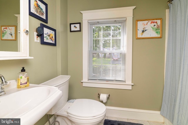 1864 Edge Hill Rd, Abington, PA 19001 - bathroom featuring a sink, toilet, curtained shower, and tile patterned flooring
