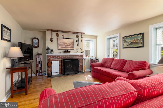 1864 Edge Hill Rd, Abington, PA 19001 - living area featuring healthy amount of natural light, wood finished floors, a brick fireplace, and baseboards