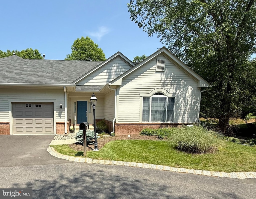 11 Birchwood Ct, Princeton, NJ 08540 - view of front of property with brick siding, an attached garage, driveway, and a front yard